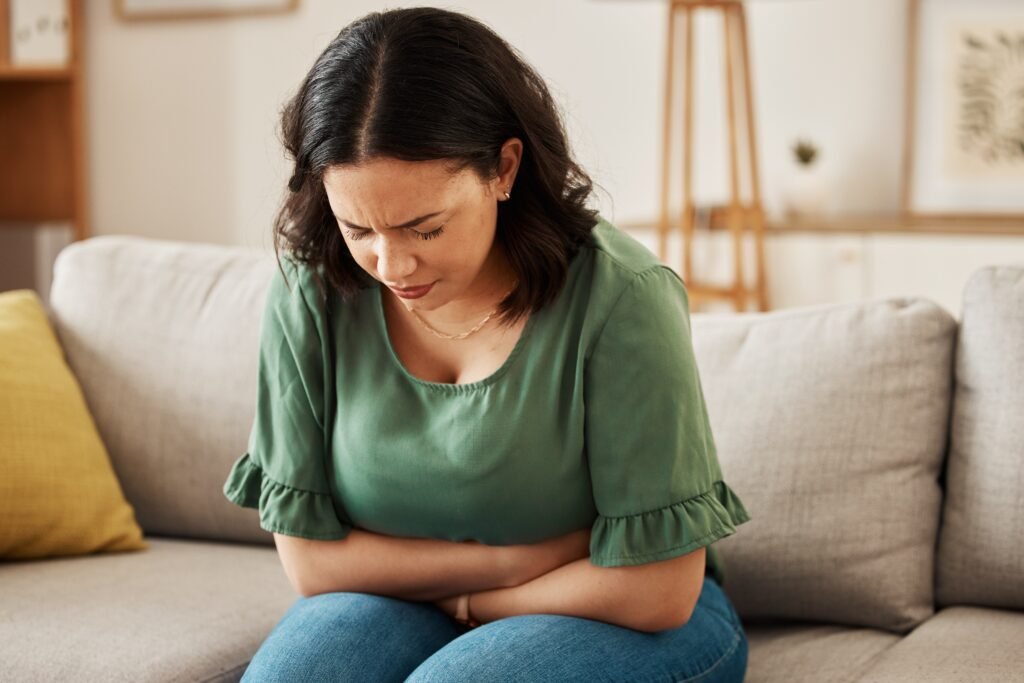 Woman experiencing lower abdominal pain possibility indicating UTI.