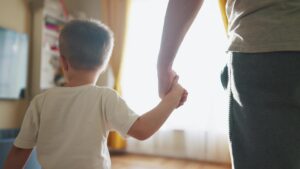 Child holding parent’s hand before paediatric urology consultation