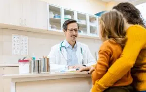 Doctor consulting parent and child about recurrent urinary tract infections in children