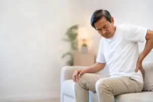 Man experiencing sudden flank pain from suspected renal colic or kidney stone